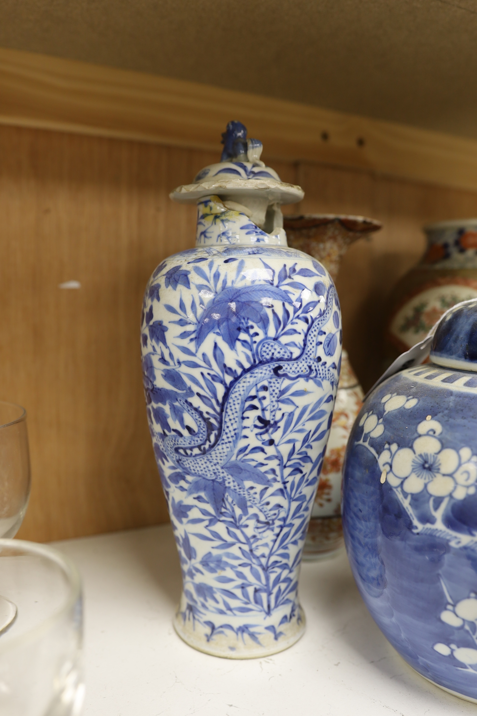 A Chinese blue and white lidded baluster vase, with damage, together with a lidded prunus ginger jar, a Japanese Kutani Export vase, a small blue and white dish (5), baluster vase and cover 27.5 cm high